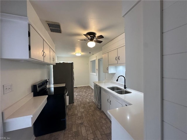 kitchen with sink, ceiling fan, black range with electric cooktop, fridge, and white cabinetry