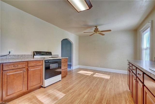 kitchen with light hardwood / wood-style floors, ceiling fan, and electric stove