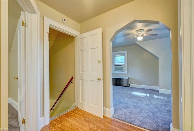 bonus room with light hardwood / wood-style flooring, radiator, cooling unit, and ceiling fan