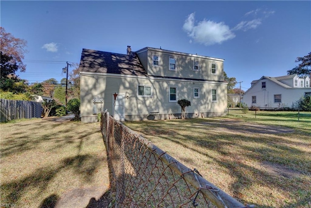 back of property featuring a lawn