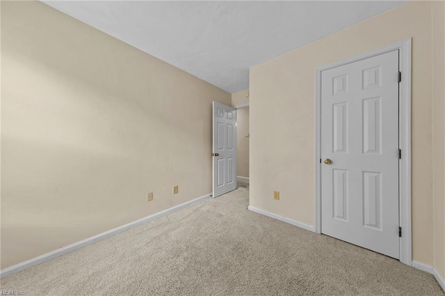 unfurnished bedroom featuring light colored carpet