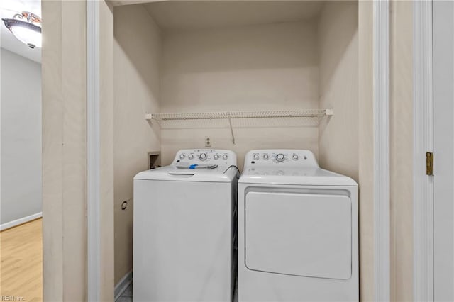 washroom featuring hardwood / wood-style floors and independent washer and dryer