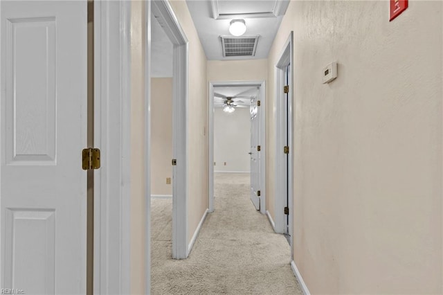 hallway with light colored carpet