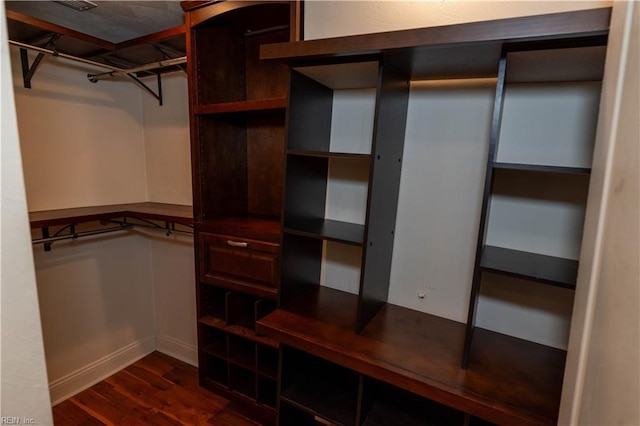 spacious closet featuring dark hardwood / wood-style floors