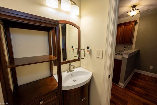 bathroom with hardwood / wood-style floors and vanity