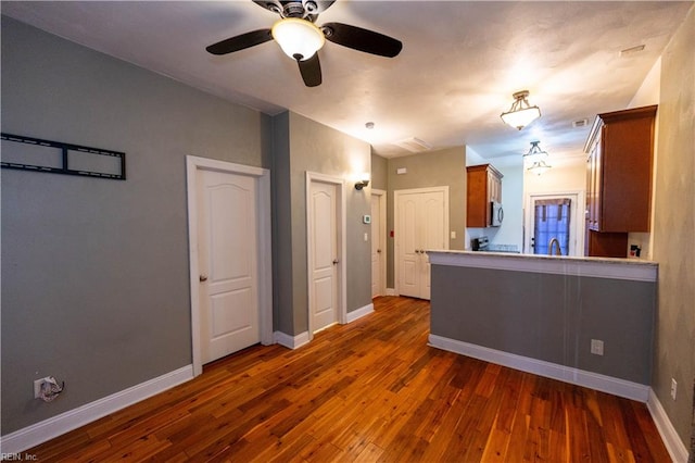 kitchen with ceiling fan, dark hardwood / wood-style flooring, and sink