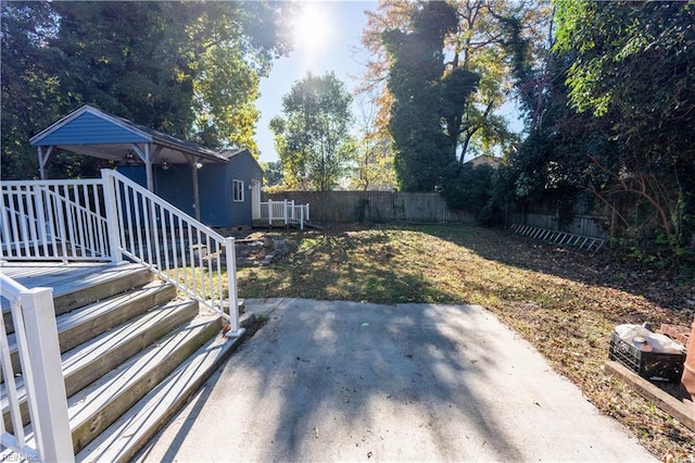 view of yard featuring a patio and a wooden deck