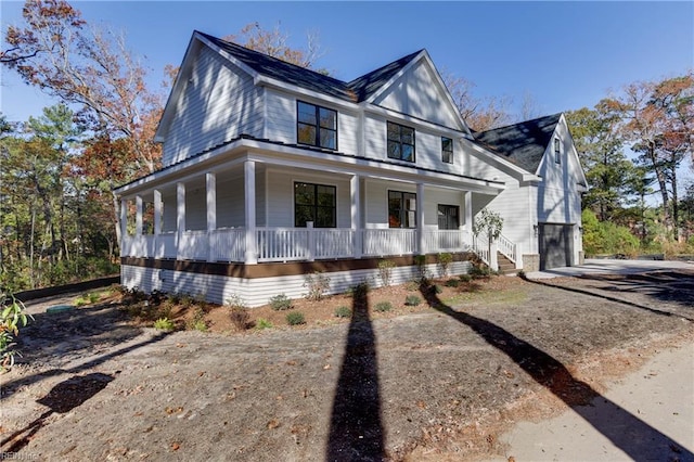 view of front of property with a porch and a garage