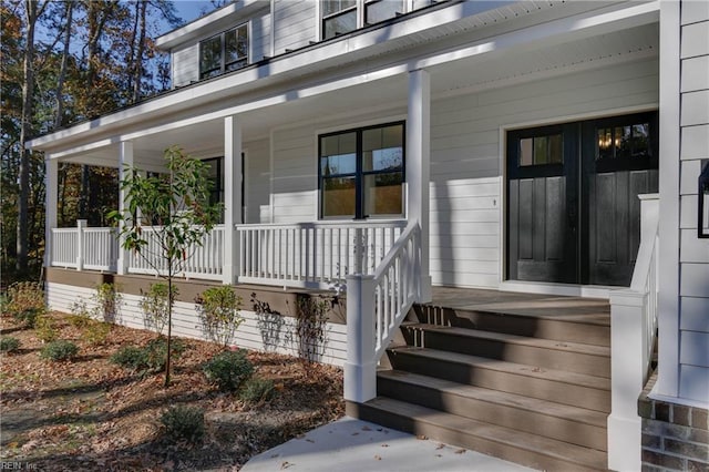 view of exterior entry featuring a porch