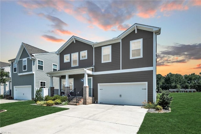 view of front of house with a yard and a garage