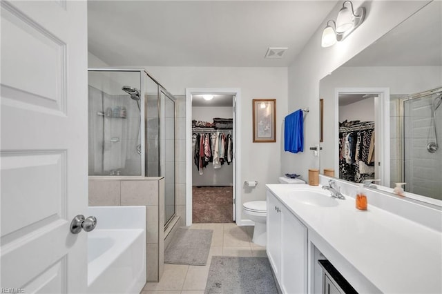 full bathroom featuring tile patterned floors, vanity, plus walk in shower, and toilet