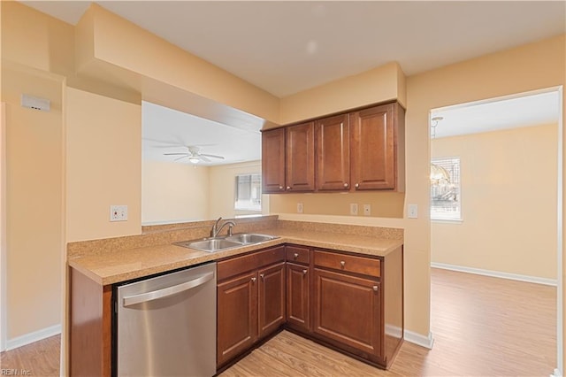 kitchen featuring light wood-style flooring, a ceiling fan, a sink, stainless steel dishwasher, and light countertops