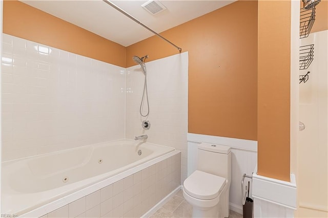 bathroom with visible vents, toilet, tile patterned flooring, and a combined bath / shower with jetted tub