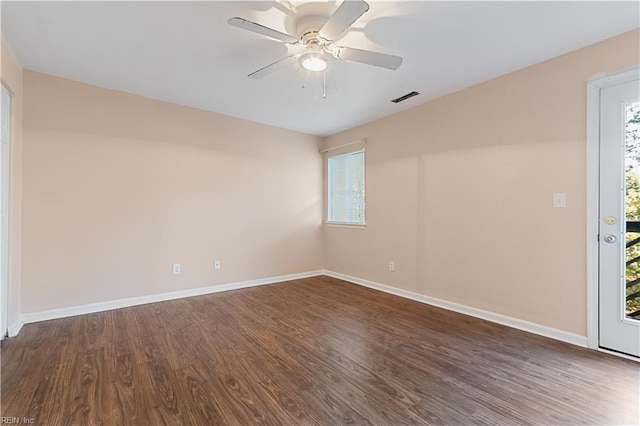 unfurnished room with visible vents, a ceiling fan, baseboards, and wood finished floors