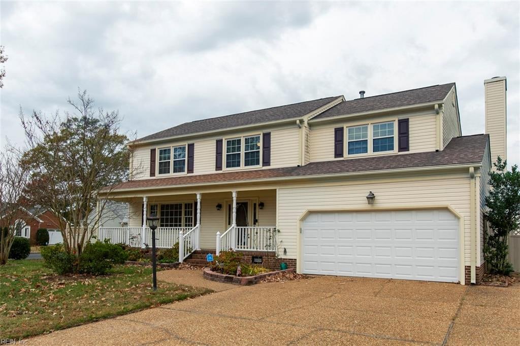 view of front of property featuring a porch and a garage