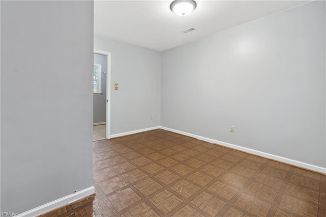 spare room featuring parquet floors