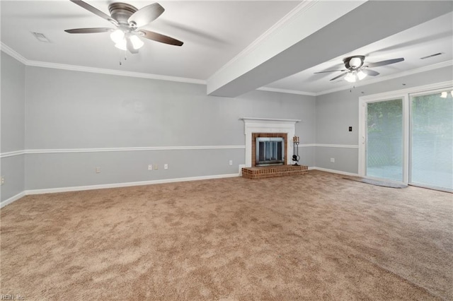 unfurnished living room featuring ceiling fan, carpet floors, crown molding, and a brick fireplace