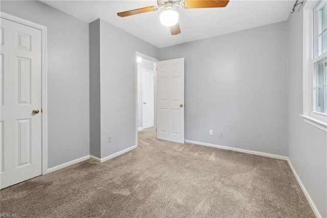 carpeted empty room with ceiling fan