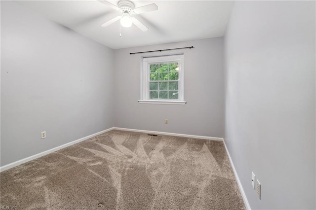 carpeted empty room featuring ceiling fan