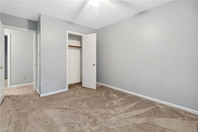 unfurnished bedroom featuring carpet, ceiling fan, and a closet