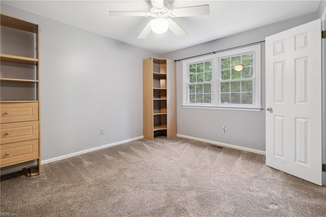 unfurnished bedroom with ceiling fan and carpet