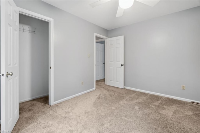 unfurnished bedroom featuring a closet, ceiling fan, and light colored carpet