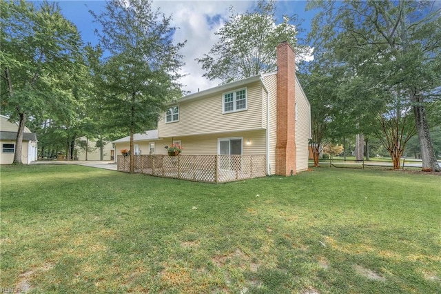 back of house featuring a yard