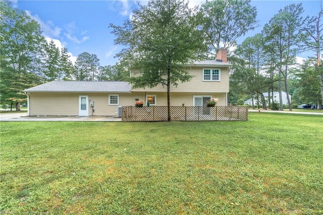 rear view of property featuring a patio area and a yard