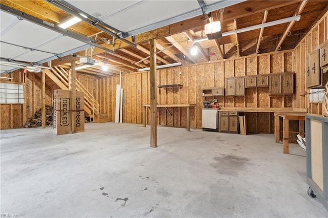 garage featuring a workshop area and a garage door opener