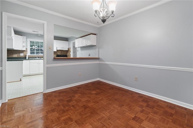 unfurnished dining area featuring dark parquet flooring, an inviting chandelier, and ornamental molding