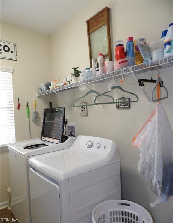 clothes washing area with washing machine and clothes dryer