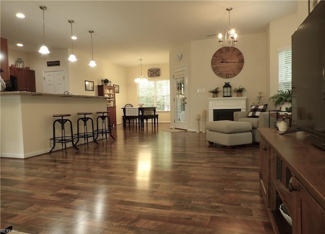 living room featuring dark hardwood / wood-style floors and an inviting chandelier