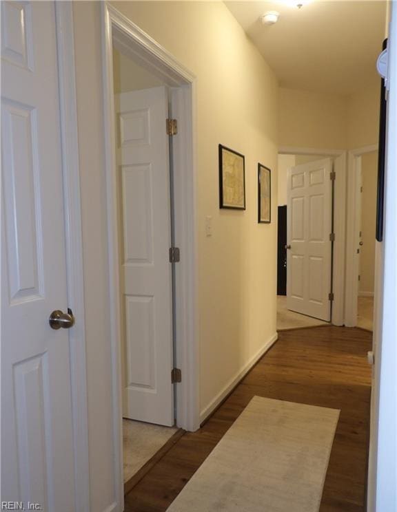 hall with dark wood-type flooring