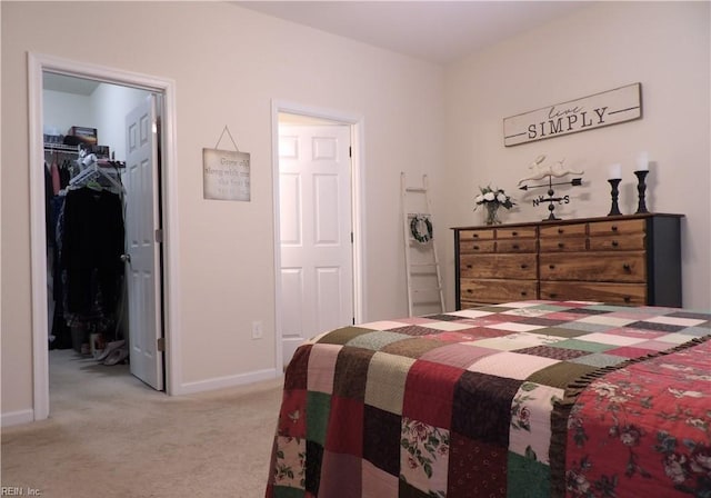 bedroom featuring light carpet, a walk in closet, and a closet