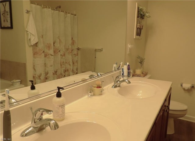 bathroom featuring hardwood / wood-style flooring, vanity, and toilet