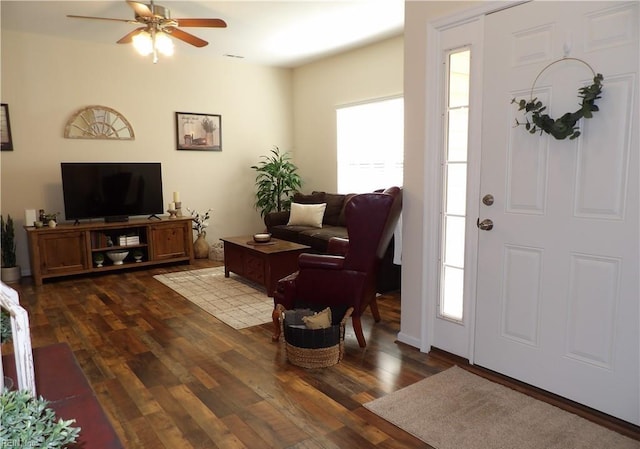 foyer entrance with dark hardwood / wood-style flooring, ceiling fan, and plenty of natural light