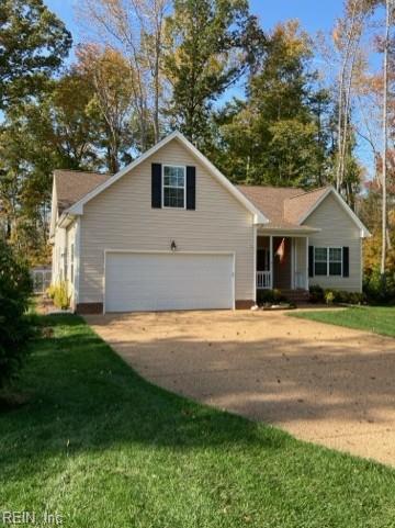 view of front of home featuring a garage and a front lawn