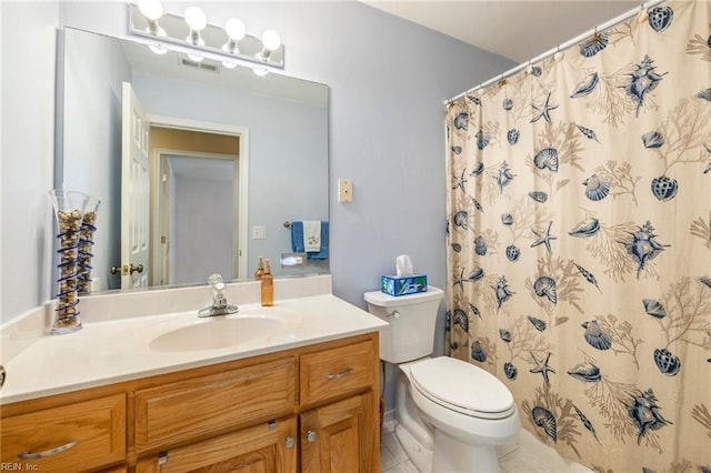 bathroom featuring toilet, a shower with curtain, vanity, and tile patterned floors