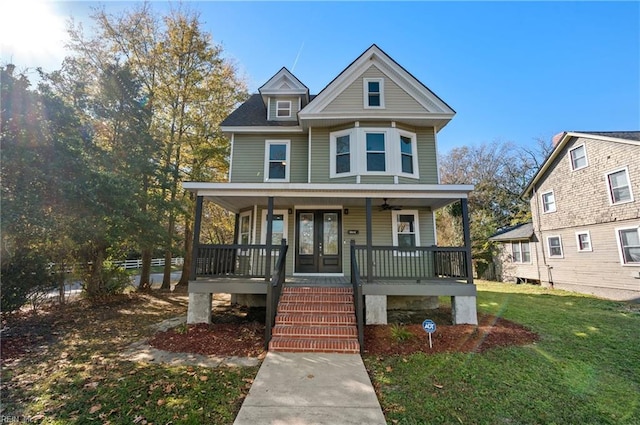 view of front of house featuring covered porch and a front lawn