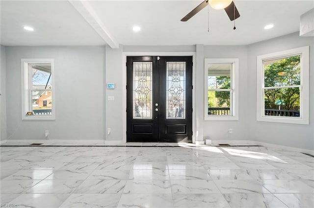 foyer featuring beam ceiling, ceiling fan, and french doors