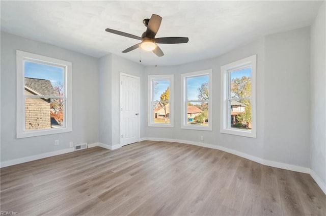 unfurnished room with ceiling fan and light wood-type flooring