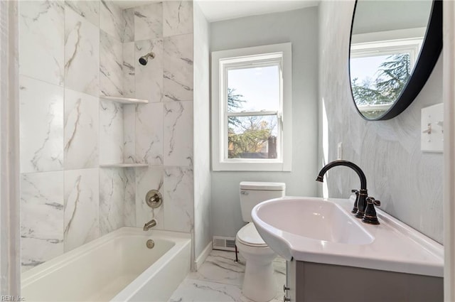 full bathroom with vanity, toilet, and tiled shower / bath