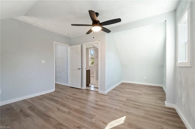 additional living space with light wood-type flooring, ceiling fan, and lofted ceiling