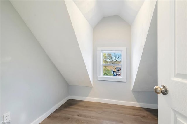 bonus room with light hardwood / wood-style flooring and lofted ceiling