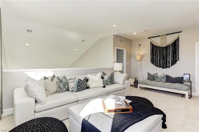 carpeted living room with vaulted ceiling