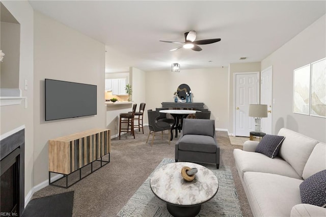 living room featuring carpet flooring, plenty of natural light, and ceiling fan