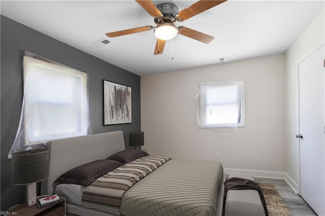 bedroom with ceiling fan and hardwood / wood-style flooring