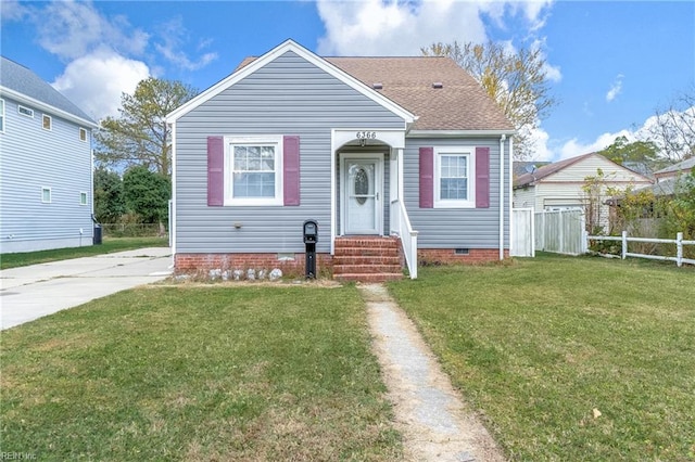 bungalow-style house with a front lawn