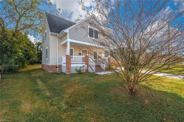 view of front of house with a front yard and a porch