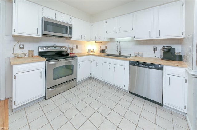 kitchen with white cabinetry, sink, and stainless steel appliances